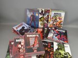 a pile of comics sitting on top of each other on a table