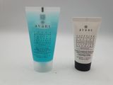 a tube of cream and a tube of lotion next to each other