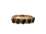 a close up of a gold ring with blue stones