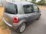 a small silver car parked on the side of the road