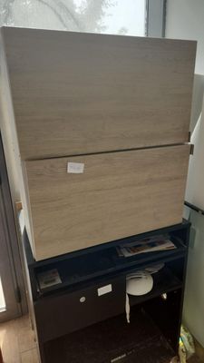 a refrigerator and a refrigerator freezer in a room