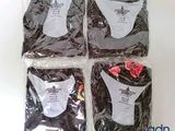 four pieces of clothing are wrapped in plastic bags on a white surface