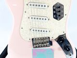 a pink electric guitar with a sticker on it