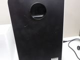 a black and white speaker sitting on a white table