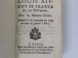 an open book with a black and white image of a coat of arms on it