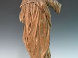 statue of a woman holding a bird in her hand on a white surface