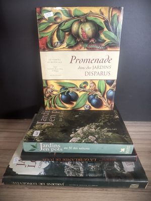three books are stacked on top of each other on a table