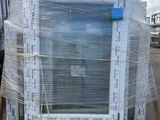 a large white refrigerator sitting on a pallet in a warehouse