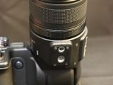 a camera with a lens attached to it on a table