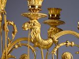 a gold candle holder with a bird on it