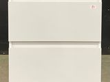 a picture of a white refrigerator sitting in a room