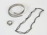 two bracelets and a ring on a white surface