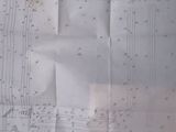 a piece of paper with a drawing of a building on it