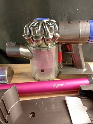 a picture of a pink and silver vacuum on a table