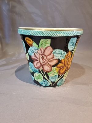 a close up of a flower pot on a table