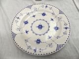 a white plate with blue flowers on it on a table