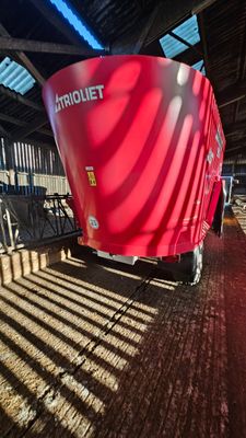 a red trailer that is parked inside of a building