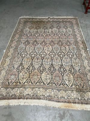 un grand tapis oriental posé sur le sol d'une pièce