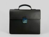 a black briefcase sitting on top of a white surface
