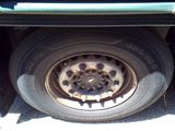 a truck with a flat tire that is parked on the side of the road