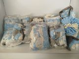 many bags of blue and white items sitting on a shelf