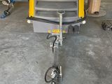an image of a small yellow trailer in a garage