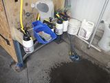 une photo d'une salle de bains avec des toilettes et un seau d'eau