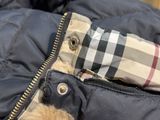 a teddy bear that is sitting in a jacket