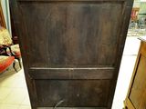 an old wooden cabinet in the middle of a room
