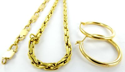 three pieces of gold jewelry on a white surface