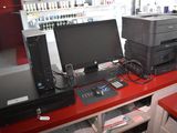 a red desk with a computer and printer on it
