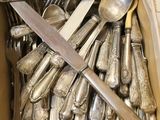 une boîte remplie de cuillères en argent, avec des cuillères à l'intérieur