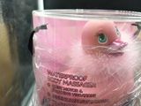 a pink rubber duck that is wrapped in plastic