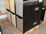 a large stack of appliances in a warehouse with boxes on the floor