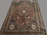 an oriental rug with a brown and black design on it