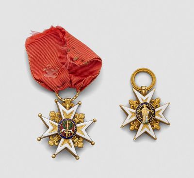 two medals and a red ribbon on a white surface