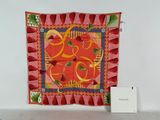 a wall hanging with a red and yellow design on it