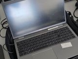 three laptops sitting on a desk with cords and cords