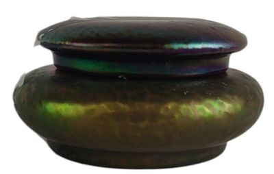 a green vase with a lid sitting on a white surface