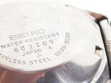 an image of a close up of a wrist watch on a white surface