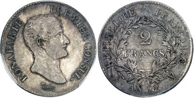 a silver coin with a portrait of a man on it