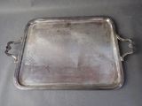 a silver tray with a handle on a table