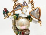 an image of a close up of a necklace with a bird on it