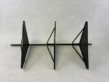 a black shelf that has a pair of triangulars on it
