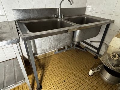 une cuisine avec un évier et une poubelle