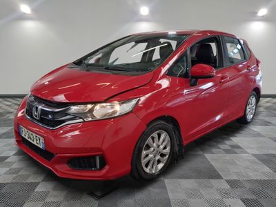 a red honda fit is parked on a checkered floor