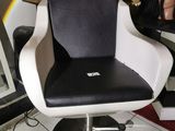 a black and white chair with a laptop on it