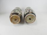 pair of chinese vases with floral designs on them on a white surface