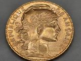a gold coin with a woman ' s head on it