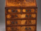 a walnut bureau on stand with three drawers